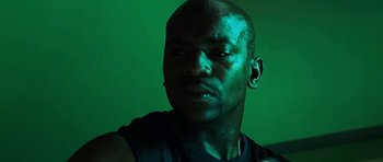 Movie still from “Dawn of the Dead” (2004), directed by Zack Snyder – A person wearing a black shirt; Close Up shot, Low angle