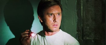 Movie still from “Dawn of the Dead” (2004), directed by Zack Snyder – A person wearing a white t - shirt; Close Up shot, Low angle