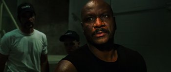 Movie still from “Dawn of the Dead” (2004), directed by Zack Snyder – A person wearing a black tank top; Close Up shot, Low angle