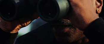 Movie still from “Dawn of the Dead” (2004), directed by Zack Snyder – A person holding an object up to their eye; Extreme Close Up shot, Low angle