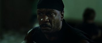 Movie still from “Dawn of the Dead” (2004), directed by Zack Snyder – An older man with a black bandana on his head; Close Up shot, Low angle