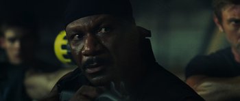 Movie still from “Dawn of the Dead” (2004), directed by Zack Snyder – A person wearing a black hat; Close Up shot, Over the shoulder angle