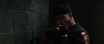 Movie still from “Dawn of the Dead” (2004), directed by Zack Snyder – A man in a black shirt and a black hat; Close Up shot, High angle