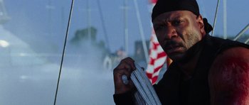 Movie still from “Dawn of the Dead” (2004), directed by Zack Snyder – A man in a black shirt holding a rope; Close Up shot, Low angle