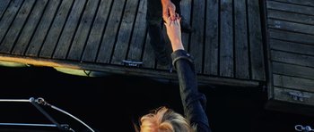 Movie still from “Dawn of the Dead” (2004), directed by Zack Snyder – Two people holding hands while standing on a dock; Extreme Close Up shot, Overhead angle