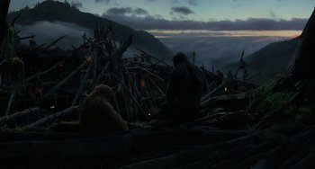 Movie still from “Dawn of the Planet of the Apes” (2014), directed by Matt Reeves – Two people sitting on a hill at night; Extreme Wide shot, Low angle
