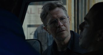 Movie still from “Dawn of the Planet of the Apes” (2014), directed by Matt Reeves – A person wearing glasses in a car; Close Up shot, Over the shoulder angle