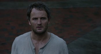 Movie still from “Dawn of the Planet of the Apes” (2014), directed by Matt Reeves – A person wearing a shirt; Close Up shot, High angle