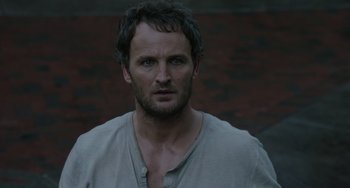 Movie still from “Dawn of the Planet of the Apes” (2014), directed by Matt Reeves – A person wearing a shirt; Close Up shot, High angle