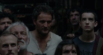 Movie still from “Dawn of the Planet of the Apes” (2014), directed by Matt Reeves – A group of people standing next to each other in a room; Close Up shot, Over the shoulder angle