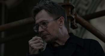 Movie still from “Dawn of the Planet of the Apes” (2014), directed by Matt Reeves – A person wearing glasses and a black shirt; Close Up shot, Over the shoulder angle