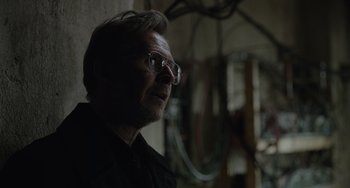 Movie still from “Dawn of the Planet of the Apes” (2014), directed by Matt Reeves – A person wearing glasses and a black shirt; Close Up shot, Over the shoulder angle