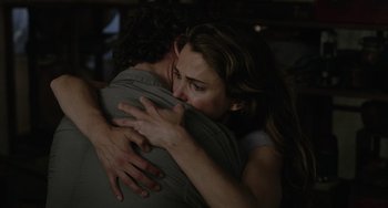 Movie still from “Dawn of the Planet of the Apes” (2014), directed by Matt Reeves – A man and a woman embracing each other; Close Up shot, Over the shoulder angle