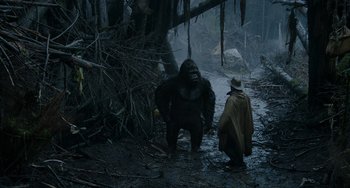 Movie still from “Dawn of the Planet of the Apes” (2014), directed by Matt Reeves – A man and a gorilla in the woods; Wide shot, Low angle