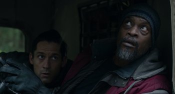 Movie still from “Dawn of the Planet of the Apes” (2014), directed by Matt Reeves – Two men sitting next to each other in the dark; Close Up shot, Low angle