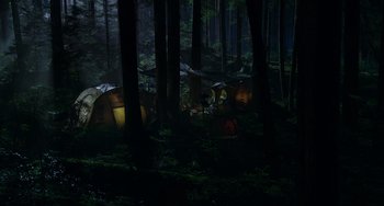 Movie still from “Dawn of the Planet of the Apes” (2014), directed by Matt Reeves – A group of tents in the middle of a forest; Extreme Wide shot, High angle
