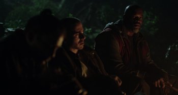 Movie still from “Dawn of the Planet of the Apes” (2014), directed by Matt Reeves – A man and a woman sitting next to each other in the dark; Medium shot, Over the shoulder angle