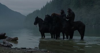 Movie still from “Dawn of the Planet of the Apes” (2014), directed by Matt Reeves – A group of monkeys riding on the backs of black horses; Wide shot, Low angle