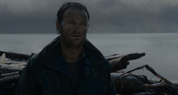 Movie still from “Dawn of the Planet of the Apes” (2014), directed by Matt Reeves – A person wearing a jacket; Close Up shot, Low angle