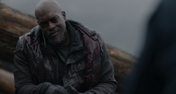 Movie still from “Dawn of the Planet of the Apes” (2014), directed by Matt Reeves – An older bald man wearing a leather jacket; Close Up shot, Over the shoulder angle