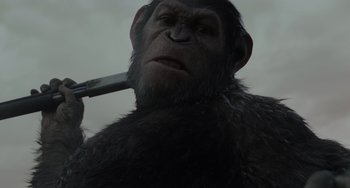Movie still from “Dawn of the Planet of the Apes” (2014), directed by Matt Reeves – A person holding a knife in his mouth; Close Up shot, Low angle