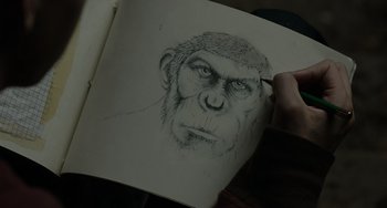 Movie still from “Dawn of the Planet of the Apes” (2014), directed by Matt Reeves – A drawing of a gorilla with a pen and pencil; Extreme Close Up shot, Over the shoulder angle