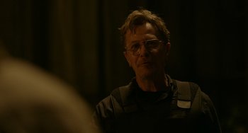 Movie still from “Dawn of the Planet of the Apes” (2014), directed by Matt Reeves – A man with glasses is looking into a mirror; Close Up shot, Over the shoulder angle