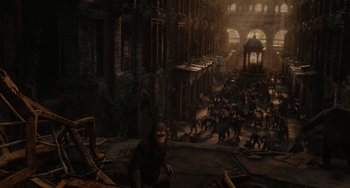 Movie still from “Dawn of the Planet of the Apes” (2014), directed by Matt Reeves – A group of monkeys in the middle of an alley; Extreme Wide shot, High angle