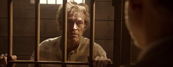 Movie still from “Dead for a Dollar” (2022), directed by Walter Hill – An old man behind bars in a jail cell; Close Up shot, Low angle