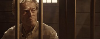 Movie still from “Dead for a Dollar” (2022), directed by Walter Hill – An older man in a jail cell looking at the camera; Close Up shot, Over the shoulder angle
