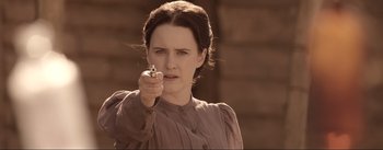 Movie still from “Dead for a Dollar” (2022), directed by Walter Hill – A young woman holding a cell phone in her hand; Close Up shot, Over the shoulder angle