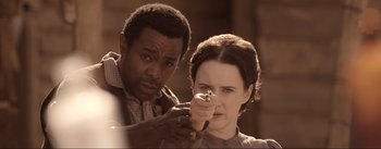 Movie still from “Dead for a Dollar” (2022), directed by Walter Hill – A man and a woman holding a knife in their hands; Close Up shot, Over the shoulder angle