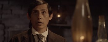 Movie still from “Dead for a Dollar” (2022), directed by Walter Hill – A man in a suit and tie looking to his left; Close Up shot, Over the shoulder angle