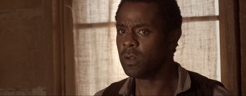 Movie still from “Dead for a Dollar” (2022), directed by Walter Hill – A person looking at the camera; Close Up shot, Over the shoulder angle