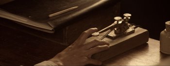 Movie still from “Dead for a Dollar” (2022), directed by Walter Hill – A person is working on a piece of wood; Extreme Close Up shot, High angle