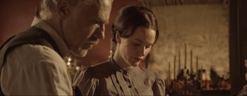 Movie still from “Dead for a Dollar” (2022), directed by Walter Hill – An older man and a young woman looking at each other; Close Up shot, Over the shoulder angle