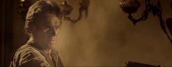 Movie still from “Dead for a Dollar” (2022), directed by Walter Hill – An old man is standing in a room; Close Up shot, Over the shoulder angle