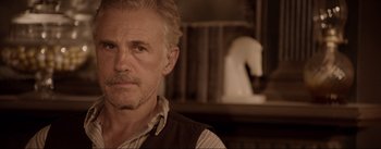 Movie still from “Dead for a Dollar” (2022), directed by Walter Hill – An older man with a beard and mustache looking at the camera; Close Up shot, Over the shoulder angle