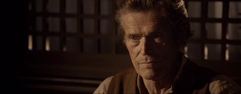 Movie still from “Dead for a Dollar” (2022), directed by Walter Hill – An older man with a beard and a mustache; Close Up shot, Over the shoulder angle