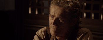 Movie still from “Dead for a Dollar” (2022), directed by Walter Hill – An older man with a goatee looking into the distance; Close Up shot, Over the shoulder angle