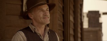 Movie still from “Dead for a Dollar” (2022), directed by Walter Hill – An older man wearing a hat and a vest; Close Up shot, Over the shoulder angle