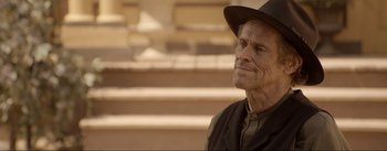 Movie still from “Dead for a Dollar” (2022), directed by Walter Hill – An older man wearing a hat and a vest; Close Up shot, Over the shoulder angle