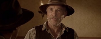 Movie still from “Dead for a Dollar” (2022), directed by Walter Hill – An older man wearing a hat and a vest; Close Up shot, Low angle