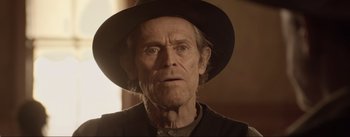 Movie still from “Dead for a Dollar” (2022), directed by Walter Hill – An old man wearing a black hat and looking at the camera; Close Up shot, Over the shoulder angle