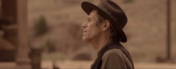 Movie still from “Dead for a Dollar” (2022), directed by Walter Hill – A man wearing a hat looking to his left; Close Up shot, Over the shoulder angle