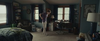 Movie still from “Dear Evan Hansen” (2021), directed by Stephen Chbosky – A man standing in a living room with his hands on his hips; Wide shot, Over the shoulder angle