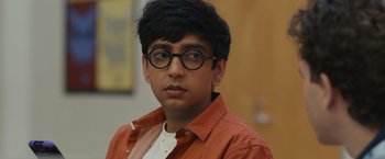 Movie still from “Dear Evan Hansen” (2021), directed by Stephen Chbosky – A young man wearing glasses and an orange shirt; Close Up shot, Over the shoulder angle