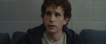 Movie still from “Dear Evan Hansen” (2021), directed by Stephen Chbosky – A man with curly brown hair wearing a striped shirt; Close Up shot, Over the shoulder angle