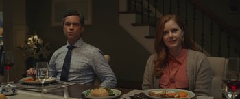 Movie still from “Dear Evan Hansen” (2021), directed by Stephen Chbosky – A man and a woman sitting at a table with plates of food; Medium shot, Over the shoulder angle