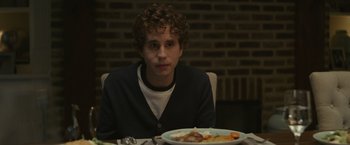 Movie still from “Dear Evan Hansen” (2021), directed by Stephen Chbosky – A man sitting in front of a plate of food; Close Up shot, Over the shoulder angle